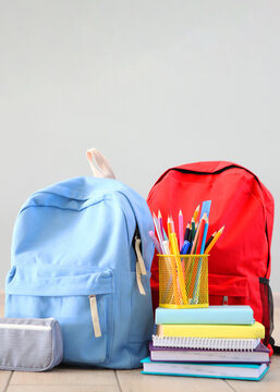 School backpack and stationery in a bright room.. Vertical photo format