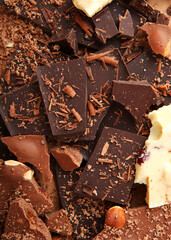 Chocolate products of different types on a colored background close-up with a place for text . Vertical photo format