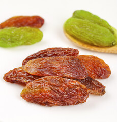 Two Colors Xinjiang Raisins Brown and Green Varieties on White Background