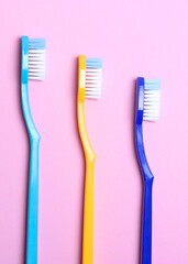 Toothbrushes on a colored background top view. Oral hygiene.. Vertical photo format
