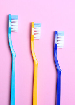 Toothbrushes on a colored background top view. Oral hygiene.. Vertical photo format