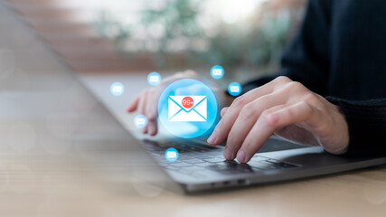 Hands typing on a laptop with email icons and inbox notification 99, symbolizing digital communication overload, work stress, business email management, productivity challenge, and office workflow.