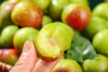 Fresh Cut Sichuan Plum with Green Flesh Display at Market