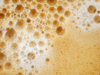 Coffee foam , creamy coffee foam, rich, frothy surface, freshly brewed cup of hot Americano. Top view of Espresso foam closeup. Creamy coffee macro shot
