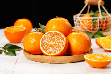 Fresh Ehime Oranges from Japan - Ripe Citrus Fruit Harvest Display on Wooden Plate with Traditional Basket
