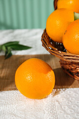 Fresh Navel Oranges from Gannan Sichuan in Wicker Basket on Rustic Wooden Table