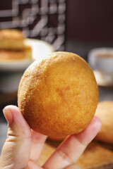 Traditional Xuanwei Ham Mooncake Held in Hand - Golden Crispy Chinese Pastry
