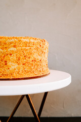 Delicious layered cake with creamy frosting on a rustic white table