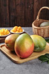 Large Fresh Panzhihua Mangoes on Wooden Board - Premium Tropical Fruit Kitchen Display