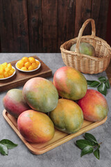 Fresh Panzhihua Mangoes on Wooden Tray - Tropical Fruit Orchard Harvest Display