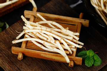 Fresh Chinese Root Vegetables on Bamboo Mat - Sichuan Guizhou Cuisine Ingredients with Mint Garnish