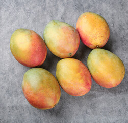 Fresh Ripe Mangoes on Gray Background - Tropical Fruit Collection