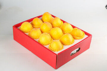 Fresh Yellow Hairy Peaches in Red Gift Box with Protective Foam Nets on White Background