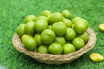 Fresh Green Plums in Wicker Basket on Grass - Healthy Organic Fruit Harvest