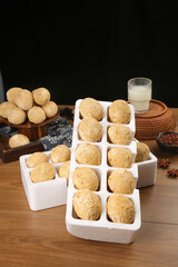 Fresh Loose Eggs with Yellow Fluffy Yolks in Cartons on Rustic Wooden Table with Milk and Basket