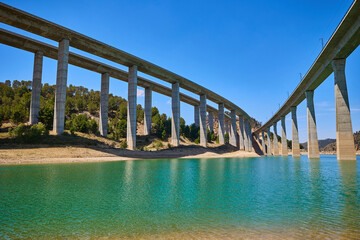 Tranquil scenery under a bridge over a reservoir with crystal clear water