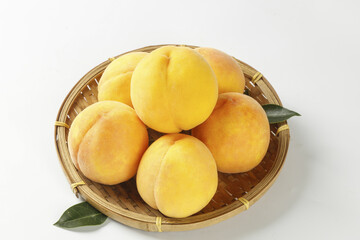 Fresh Peach Fruits in Wicker Basket on White Background - Organic Summer Produce