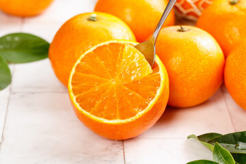 Fresh Orange Citrus Fruit Cut in Half with Spoon - Natural Juicy Segments and Beautiful Harvest