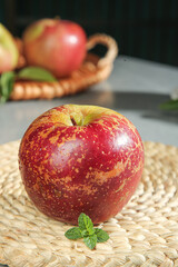 Fresh Red Apple with Mint on Wicker Basket - Healthy Organic Fruit Still Life