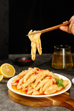 Spicy Boneless Chicken Feet Asian Cuisine Dish with Chopsticks and Lemon Garnish
