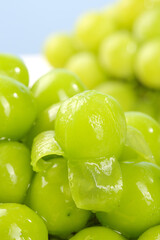 Fresh Green Seedless Grapes with Water Droplets in Sunny Light