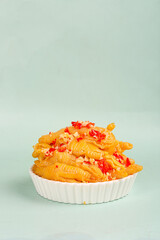 Spicy Boneless Chicken Wings with Red Chili in White Bowl on Green Background