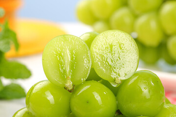 Fresh Green Grapes Cut in Half with Citrus Background - Healthy Organic Fruit for Wellness and Nutrition