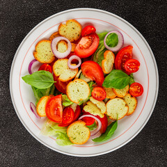 Panzanella salad tomato, croutons, onions vegetables dish natural product tasty snack fresh delicious gourmet food background on the table rustic top view copy space