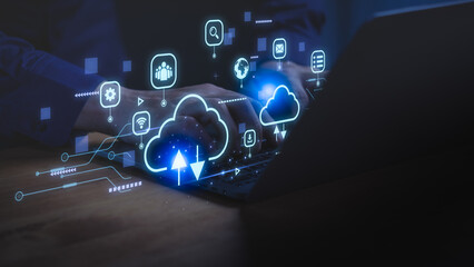 Close-up of hands typing on laptop with glowing cloud computing icons, representing data storage, digital technology, online network, file sharing, and innovative cloud solutions for business.