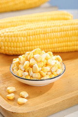 Fresh Sweet Corn Kernels in Bowl with Corn Cobs on Wooden Board