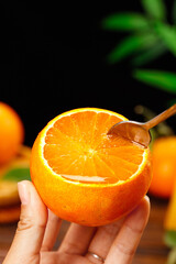 Freshly picked orange with homemade jelly spoon - citrus fruit and preserve concept
