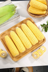 Fresh Sweet Yellow Corn on the Cob Arranged on Wooden Tray with Basket - Healthy Organic Vegetable Harvest
