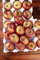 Fresh Organic Apples in White Tissue Paper on Rustic Wood Background - Healthy Fruit Display