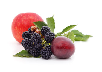 Red apple, purple plum and black blackberry isolated on white.