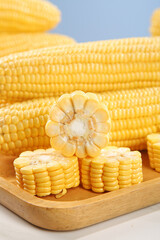 Fresh Yellow Corn Cobs on Wooden Display Board with Shallow Focus