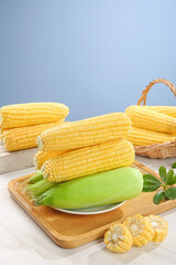 Fresh Sweet Yellow Corn Cobs on Wooden Board with Basket - Market Fresh Produce