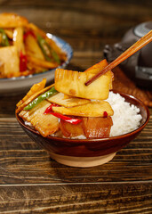 Freshly Picked Bamboo Shoots Stir-Fried with Bacon Over Rice - Asian Cuisine in Wooden Bowl