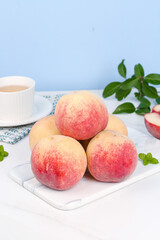 Fresh Golden Red Peaches from Shandong Qingzhou China on Marble Board with Tea Cup Autumn Winter Food Photography