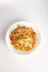 Asian Stir-Fried Noodles with Vegetables and Tofu in White Bowl on White Background