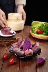 Fresh Purple Sweet Potatoes with Bamboo Steamer and Vegetables on Wooden Table - Healthy Vegetarian Cooking Ingredients