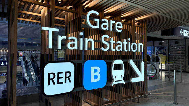 Paris, France- January 14, 2025: Gare Train Station sign illuminated at night, showcasing modern architecture