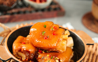 Gourmet Braised Pork Knuckle in Golden Sauce - Traditional Asian Culinary Dish with Chili and Scallion Garnish