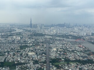 Aerial view of Ho Chi Minh City as we approach the airport for landing - District 1 in the distance, the Saigon river also seen as it snakes through the city