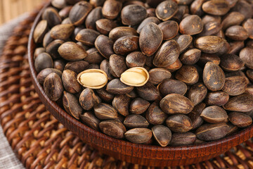 Wild Pine Nuts from Yunnan Mountains in Traditional Basket - Natural Tree Fruit Harvest Display