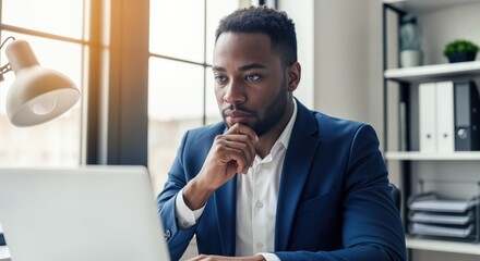 Focused Black Businessman Working on Laptop in Modern Office