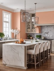 Fototapeta premium A large, light-colored marble island in a peach-toned kitchen.