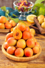 Fresh Organic Apricots in Wooden Bowl - Healthy Summer Fruit Display on Rustic Kitchen Table