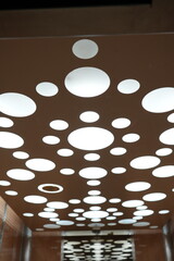 Modern elevator ceiling light design featuring circular pattern in Benidorm, Spain interior architecture.