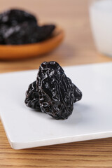 Dried Prunes from Xinjiang China on White Plate - Healthy Dehydrated Fruit Snack