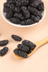 Dried Black Mulberries from Xinjiang - Wild Sour Berries in Bowl and Wooden Spoon for Cooking Ingredients
